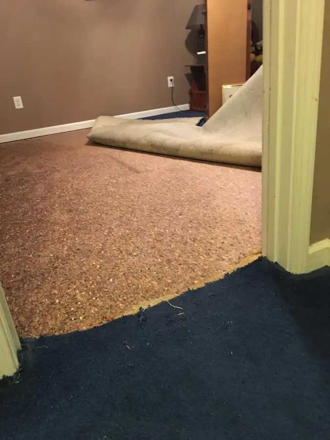 Carpet pad removal revealing water damage during Water Mitigation Services in Jamesburg